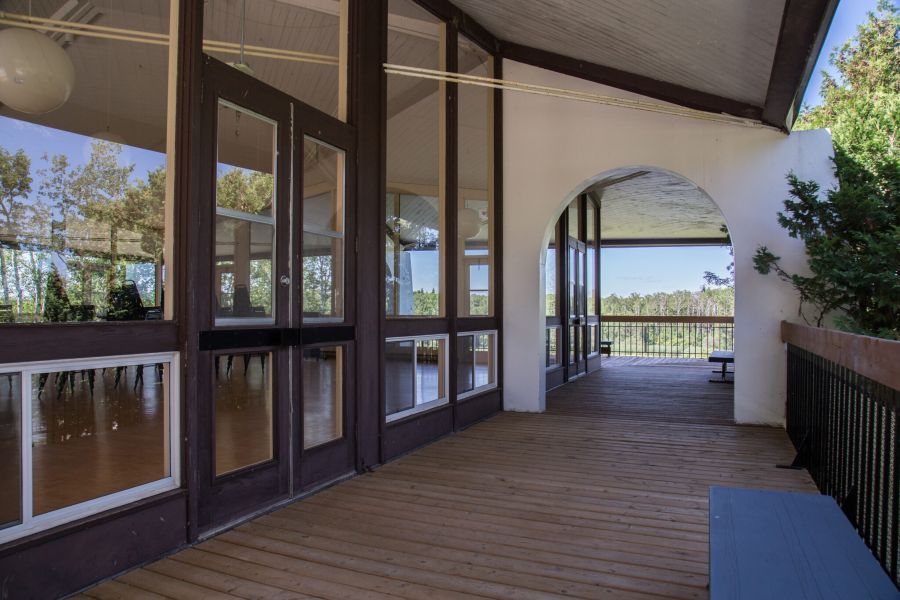 a deck overlooking the grounds of a large garden